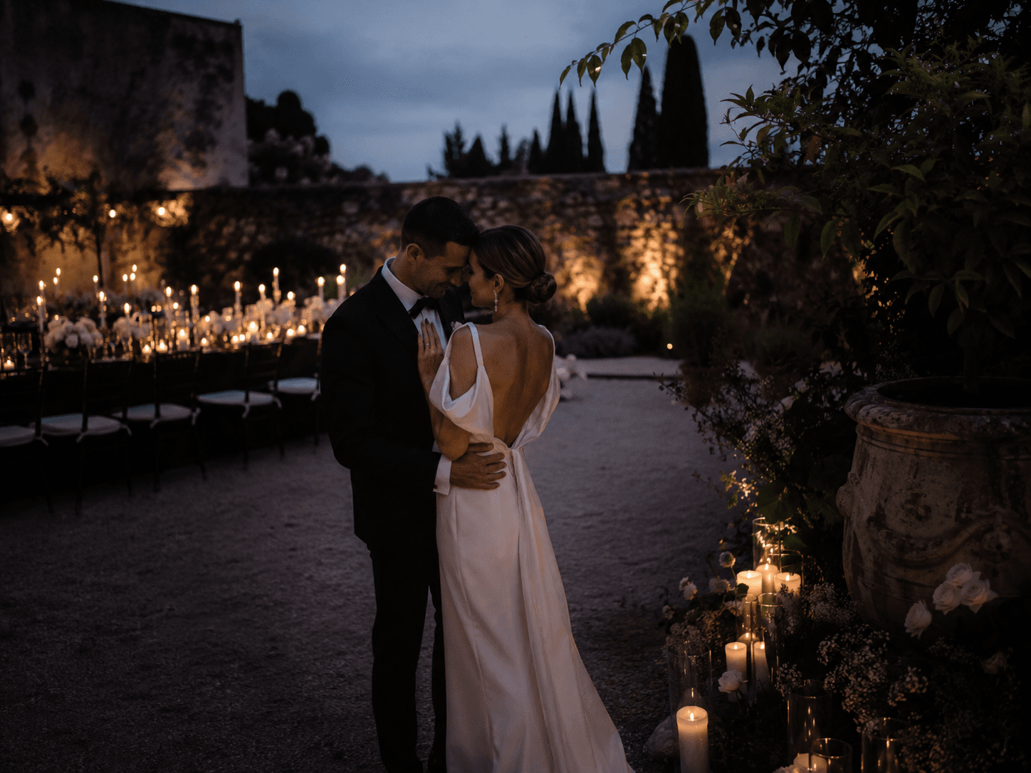 A newly married couple walking through a garden after their ceremony